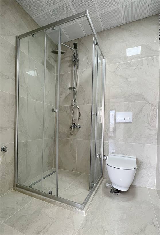 Duşakabin ve asma klozetli, seramik kaplı banyo